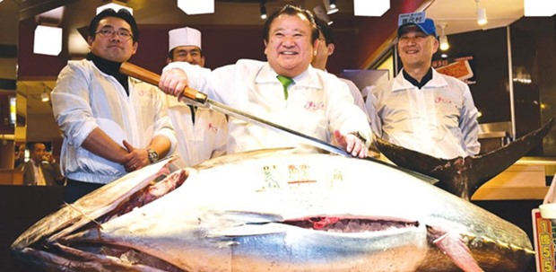 Sushi chain chief Kiyoshi Kimura displays a 200kg bluefin tuna near Tokyou2019s Tsukiji fish market yesterday.