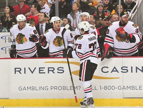 Artemi Panarinof the Chicago Blackhawks is congratulated by his bench after scoring a goal against the Pittsburgh Penguins on Tuesday.