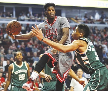Chicago Bulls guard Jimmy Butler (21) looks to pass the ball against Milwaukee Bucks forward Giannis Antetokounmpo (34) during the first half of their NBA game on Tuesday. Picture: Kamil Krzaczynski-USA TODAY Sports