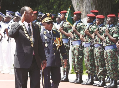 A November 3, 2015, file photo of Ivory Coastu2019s President Alassane Ouattara and Chief-of-Staff General Soumaila Bakayoko reviewing the honour guard at the Presidential Palace in Abidjan.