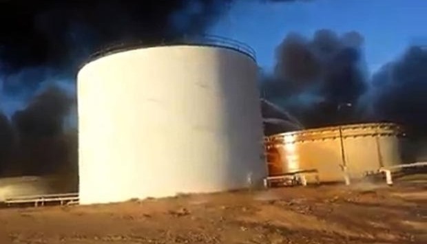 An image grab taken from a video uploaded on social networks shows a petroleum storage tank burning at Al-Sidra oil terminal, near Ras Lanuf in the so-called ,oil crescent, along Libya's northern coast.  At least four petroleum storage tanks were set ablaze during deadly fighting as the Islamic State group tries to seize coastal export terminals in eastern Libya.