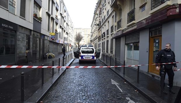 French police are seen behind a police cordon at the Rue des Islettes near Barbes-Rochechouart metro station in Paris on after police shot a man dead as he was trying to enter a police station.