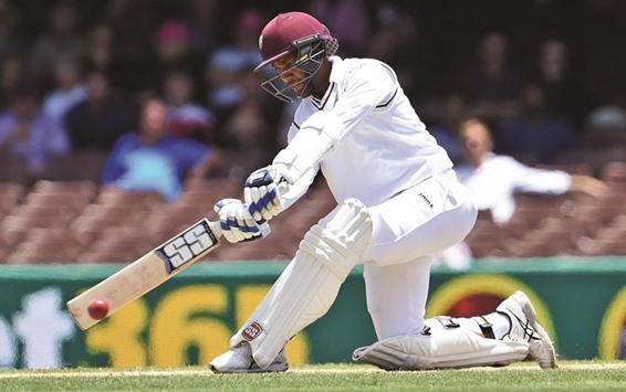 West Indies batsman Denesh Ramdin sweeps a ball from the Australian bowling on the final day of the third Test in Sydney yesterday. (AFP)