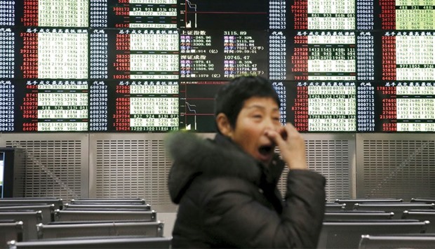 An investor yawns in front of an electronic board showing stock information, after the new circuit breaker mechanism suspended yesterdayu2019s stocks trading in Shanghai.