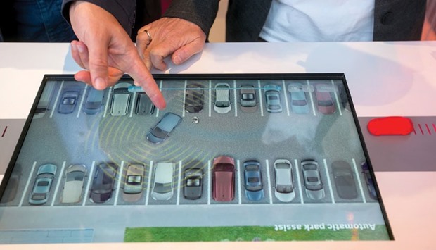 A touchscreen panel shows a demonstration of an automated car parking assistance app at Robert Bosch driverless technology press event in Boxberg, Germany in this photo taken on May 19, 2015. The market for automated-driving systems might total $42bn by 2025, Boston Consulting Group estimated in January last year. One of every 10 vehicles sold worldwide by 2030 may be fully self-driving, and China is pushing domestic carmakers to develop that expertise in order to stimulate economic growth and maintain relevance against US and European rivals.