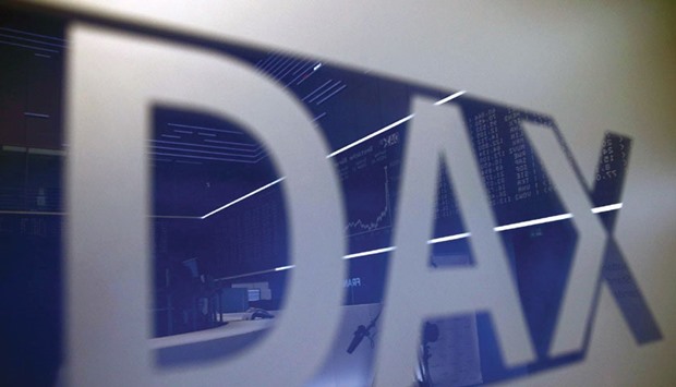 The trading floor of the Frankfurt Stock Exchange is reflected in a DAX sign. European shares fell sharply yesterday after China accelerated the depreciation of the yuan, sending currencies across the region reeling and global stock markets tumbling.