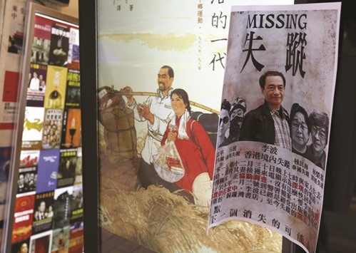A printout showing Lee Bo and four other missing colleagues is displayed outside a bookstore in the Causeway Bay shopping district of Hong Kong.