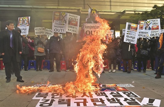 South Korean conservative activists burn an effigy of North Korean leader Kim Jong-Un during a rally in Seoul yesterday.