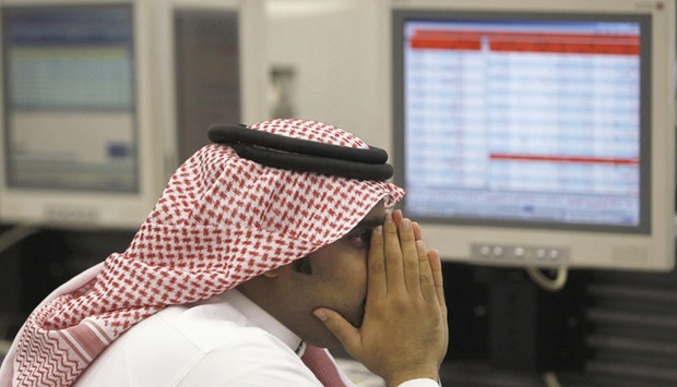 A Saudi trader monitors stocks at the Saudi Investment Bank in Riyadh (file). The Saudi stock index sank 4.5% yesterday, its biggest daily drop since August, to close at 6,225 points, its lowest finish since December 2011. It closed within just 35 points of the dayu2019s low.