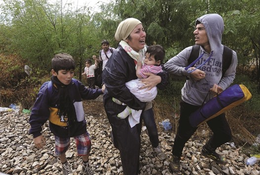 Migrants cry and walk towards Gevgelija in Macedonia after crossing Greeceu2019s border in this file photo.