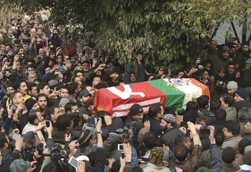 Mourners carry the coffin of Mufti Mohamed Sayeed (INSET) in Srinagar yesterday.