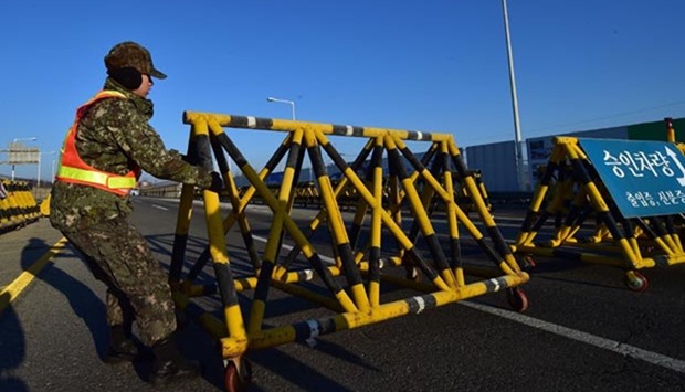 A South Korean soldier sets a barricade on the road leading to North Korea's Kaesong joint industrial complex at a military checkpoint in the border city of Paju near the Demilitarised zone dividing the two Koreas on Friday.