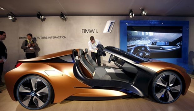 People look over the BMW i Vision Future Interaction concept car during the 2016 CES trade show in Las Vegas. The car includes BMW AirTouch technology that lets the driver control various functions with simple gestures.