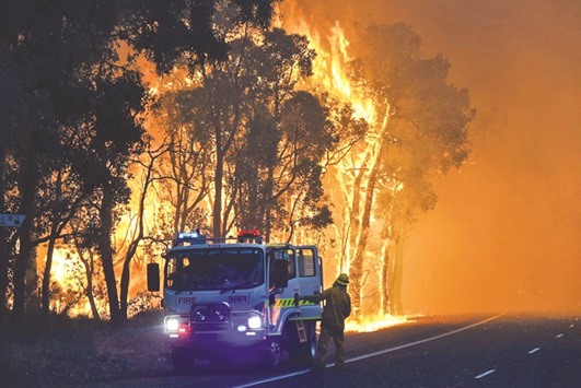 A handout photo released yesterday by the Department of Fire and Emergency Services shows firefighters battling a fire at Waroona in Western Australia.