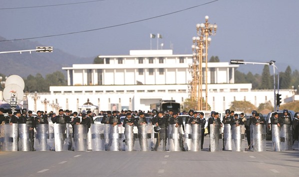 Riot policemen cordon off a street leading  to President House during a protest rally in Islamabad yesterday.