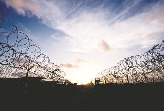 The razor wire-topped fence and a watch tower at the abandoned u201cCamp X-Rayu201d detention facility at the US naval station in Guantanamo Bay, Cuba.  The US Department of Defence yesterday announced  the repatriation of Faez Mohamed Ahmed al-Kandari from the detention facility at Guantanamo Bay to Kuwait.