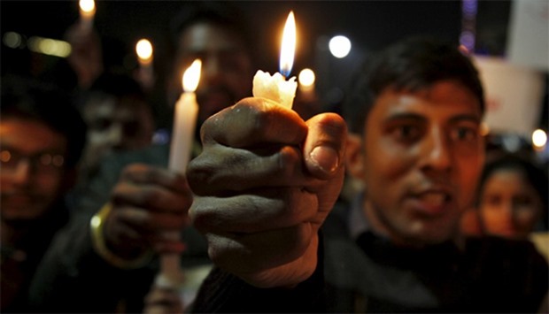 Students take part in a candlelight vigil for the Indian soldiers killed in a militant attack at Pat
