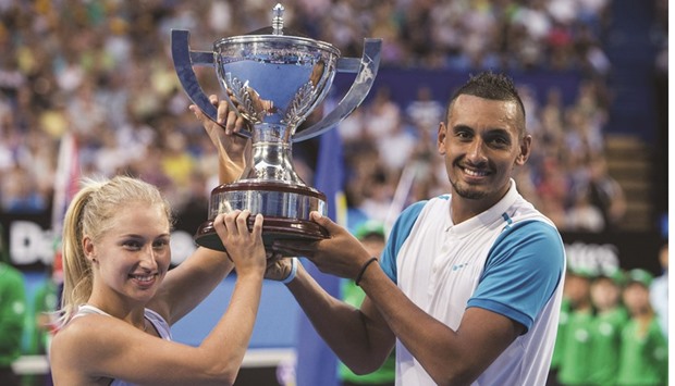 Daria Gavrilova (left) and Nick Kyrgios of Australia hold the Hopman Cup after winning the 2016 tournament against Ukraine in Perth yesterday. (Reuters)