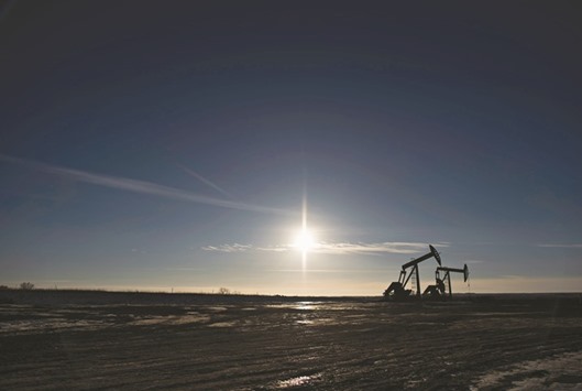 The silhouette of pumpjacks is seen on the site of an oil well outside Williston, North Dakota, US. Rigs targeting oil in the US fell by 20 to 516, after more than 130 were idled since August, Baker Hughes said on its website on Friday.