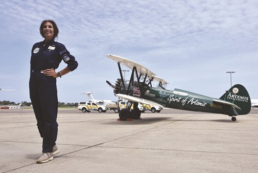 Curtis-Taylor poses after arriving in her vintage, open-cockpit 1942 Boeing Stearman aircraft at Sydney International airport yesterday.