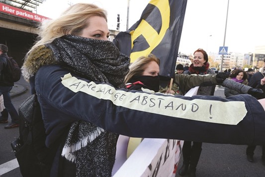 A German far-right supporter demonstrates with a sticker reading u2018an arm-length distanceu2019, referring to the suggestion by Cologneu2019s mayor for women on how to prevent assault by men.