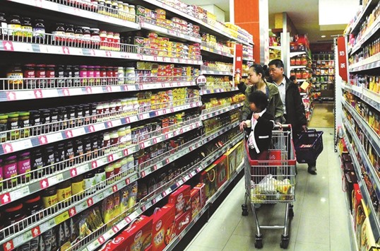Shoppers at a supermarket in Beijing. The producer price index in China was unchanged at minus 5.9% in December, the National Bureau of Statistics said yesterday.