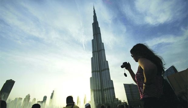 Tourists take photographs of Burj Khalifa in Dubai. GCC VAT, which is expected to be 5%, is being planned for the rollout from 2018.