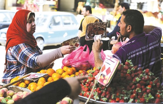 An Egyptian woman shops at a vegetable market in Cairo (file). Egyptu2019s economic reforms, which helped the nation finalise a $12bn International Monetary Fund loan, have created new hardships in the country of 92mn people, about half of whom live near or below the poverty line.