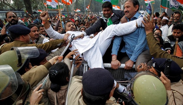 Demonstrators try to cross a police barricade during a protest organized by India's main opposition Congress party against demonetization, in Chandigarh .