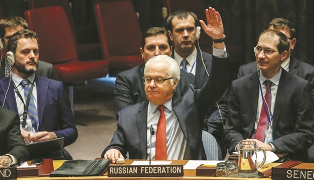 Russian ambassador to the UN Vitaly Churkin (centre) votes at the Security Council on a Russian-Turkish peace plan for Syria, yesterday at UN Headquarters in New York. The vote was unanimous for the ceasefire.