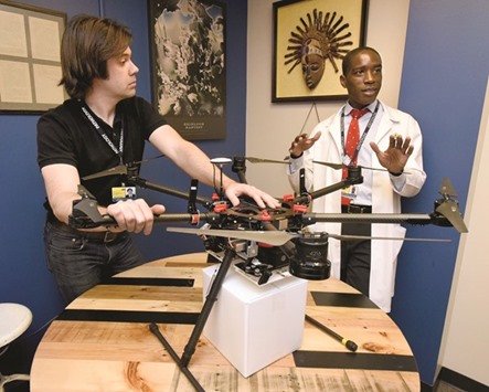 Jeff Street, drone engineer, left, and Dr Timothy Amukele, Director of Clinical Laboratories, with their multi-rotor drone at Johns Hopkins Bayview Medical Center in Baltimore. They are testing drone technology for transporting blood quickly.