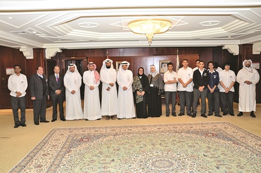 Qatar Academy students and faculty with al-Shaibei among others at QIIBu2019s corporate office at Grand Hamad Street.