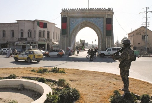 An Afghan National Army (ANA) soldier stands guard near the Kandahar governor guest house building where a bomb blast killed mainly government officials or diplomats from the United Arab Emirates, in Kandahar.