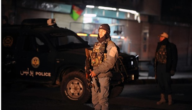 Afghan policemen standing guard at the site of an explosion near the governor's compound in Kandahar. AFP
