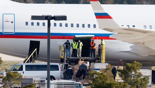 A Russian aircraft is loaded with cargo at Dulles International Airport December 31, 2016, in Sterling, Virginia, just outside Washington, DC. The special flight arrived to pickup Russian diplomats expelled by US President Barack Obama as part of sanctions imposed on Russia for suspected cyberattacks during the US election.