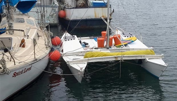 The damaged yacht of a New Zealand man and his six-year old daughter, who were missing at sea for more than a month, sits next to other boats in Ulladulla Harbour, south of Sydney on Thursday, after they sailed it across the 2,000 km Tasman Sea.