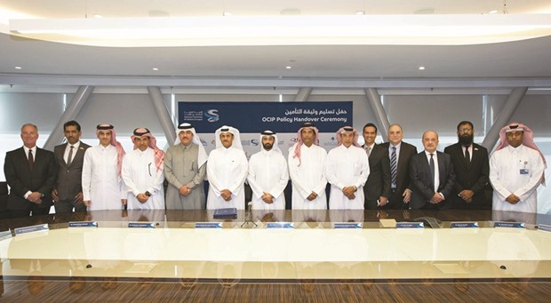 Al-Thawadi (seventh left) with Sheikh Abdullah among other top executives during the award of the insurance contract for capital expenditure works related to the construction of 2022 FIFA tournament stadiums to the National Insurance Consortium (NIC).