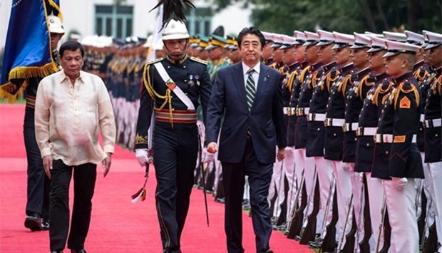 Philippine President Rodrigo Duterte and Japanese Prime Minister Shinzo Abe inspect an honour guard during a welcoming ceremony at the Malacanang Palace in Manila on Thursday.