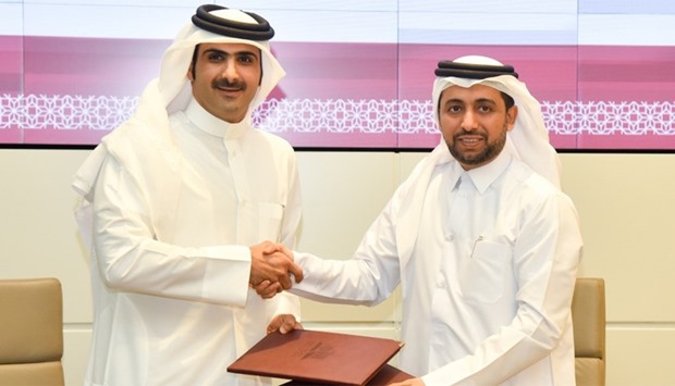 QMC CEO Sheikh Abdulrahman bin Hamad al-Thani and QU president Dr Hassan al-Derham shake hands after signing the agreement