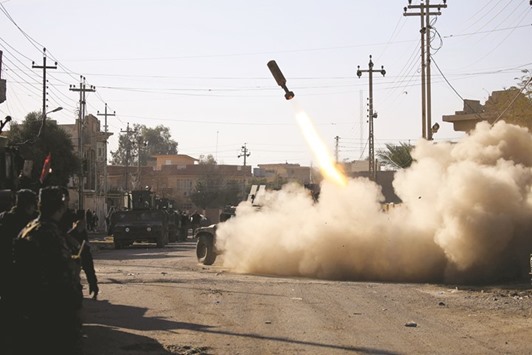 Members of the Iraqi rapid response forces fire a missile toward Islamic State militants during a battle in the Somer district of Mosul.