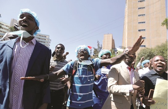 Kenyan doctors shout slogans to demand fulfilment of a 2013 agreement between their union and the government that would raise their pay and improve working conditions, outside the employment and labour relations courts in Nairobi, Kenya.
