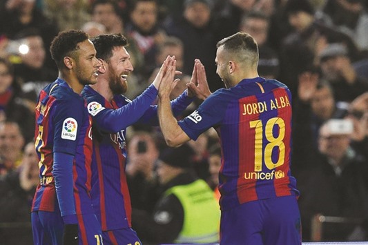Barcelonau2019s Lionel Messi (centre) celebrates with teammates Neymar (left) and Jordi Alba after scoring a goal during the Spanish Copa del Rey (Kingu2019s Cup) round of 16 second leg match against Athletic Club de Bilbao at the Camp Nou in Barcelona. (AFP)