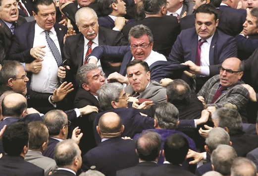 Ruling AK Party and main opposition CHP lawmakers scuffle in parliament during deliberations over an 18-article bill to change the constitution to create an executive presidency.