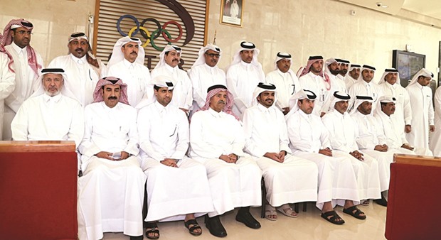 Qatar Olympic Committee (QOC)  president HE Sheikh Joaan bin Hamad al-Thani and secretary-general Dr Thani bin Abdulrahman al-Kuwari pose with elected officials of sports federations during the QOC general assembly yesterday.