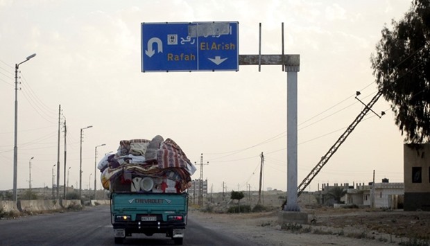 A pickup truck, filled with a family's belongings, leaves the border area in northern Sinai, where authorities are battling insurgents on the high way between Al-Arish and the border town of Rafah, Egypt.  File picture, May 25, 2015. Reuters
