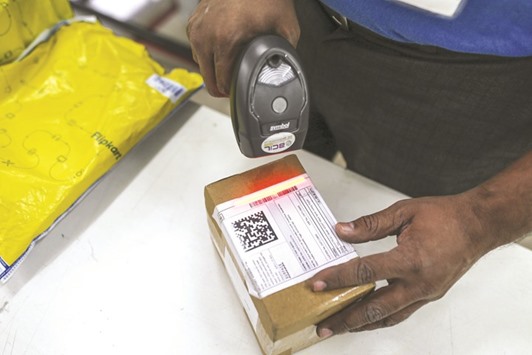 A deliveryman for Flipkart Online Servicesu2019 Ekart Logistics service scans the barcode on a package at the companyu2019s office in Bengaluru, India. A source close to Flipkart added that Tiger Global, the US hedge fund that owns about a third of the company, wants to be more closely involved in Flipkartu2019s operations.