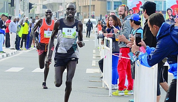 Kenyan runner Henry Kilagat breaks away from compatriot, Bernard Kipsang Chumba in the final stretch of the 42k to win the Ooredoo Marathon. PICTURE: Shaji Kayamkulam.