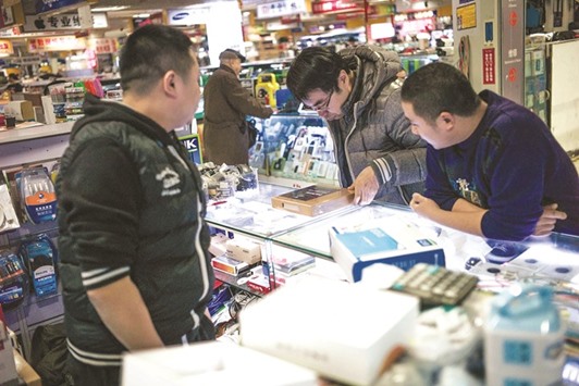 A client buys goods in a shopping mall in Beijing. Chinese exports fell more than expected in December, data showed yesterday, deepening concerns about the trade outlook for the worldu2019s number-two economy as Donald Trump prepares to take office.
