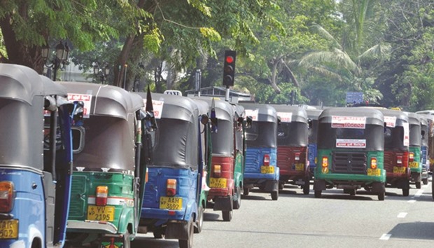 Three-wheelers crowd on a street without taking passengers during a strike in Colombo last month. Hundreds of three-wheeler drivers associated with the United National Three Wheeler Drivers and Industry Workers Union in Sri Lanka went on strike in December against the governmentu2019s proposal to raise the average traffic fine of 500 rupees to 25,000 rupees ($166) from January.