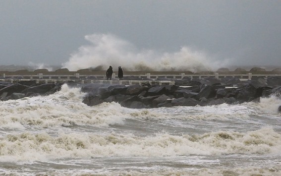 Waves crash against a dam as storm winds and a spring storm cross the country in Ostend, Belgium yesterday.